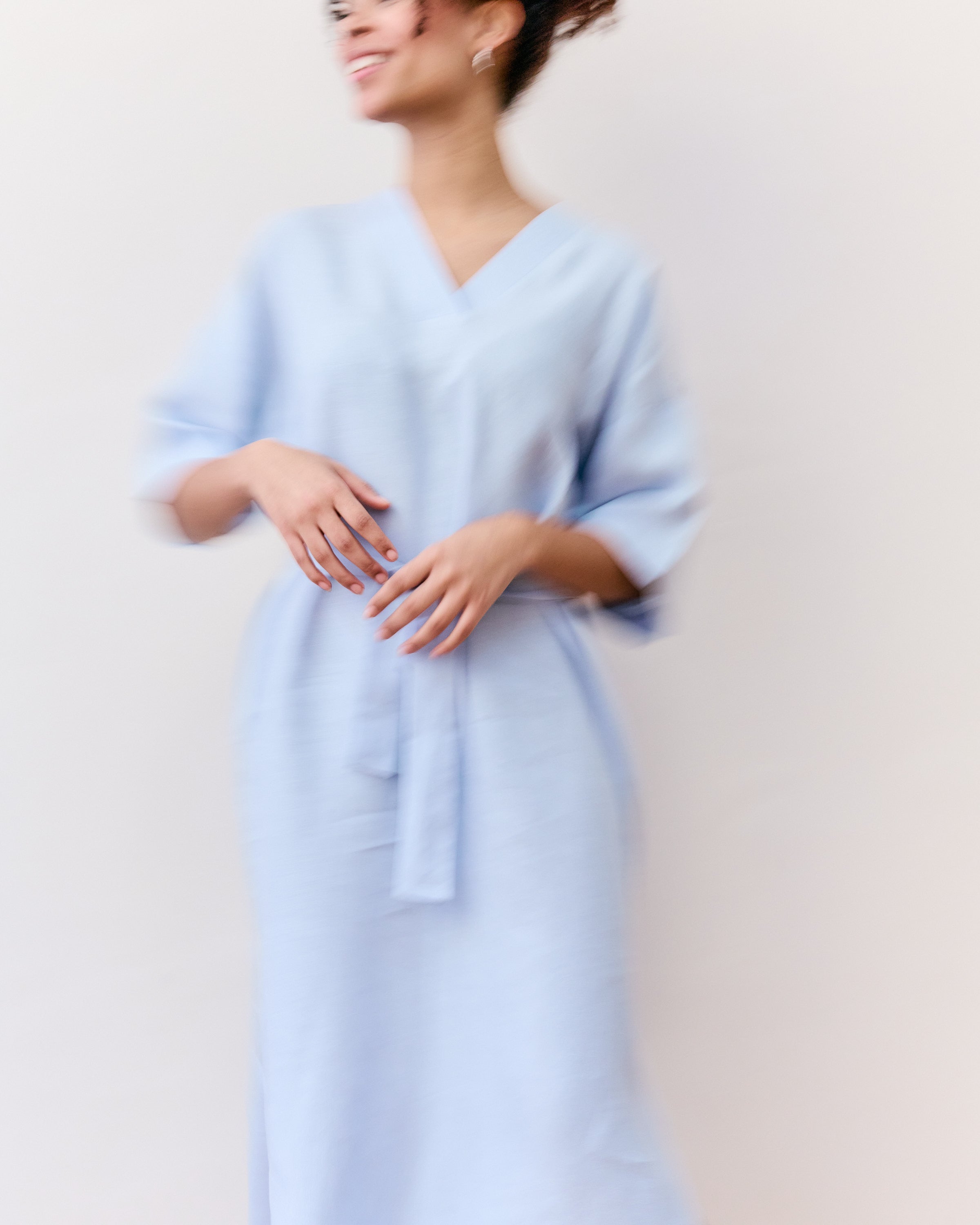 Comfortable, straight, light blue linen dress with belt.