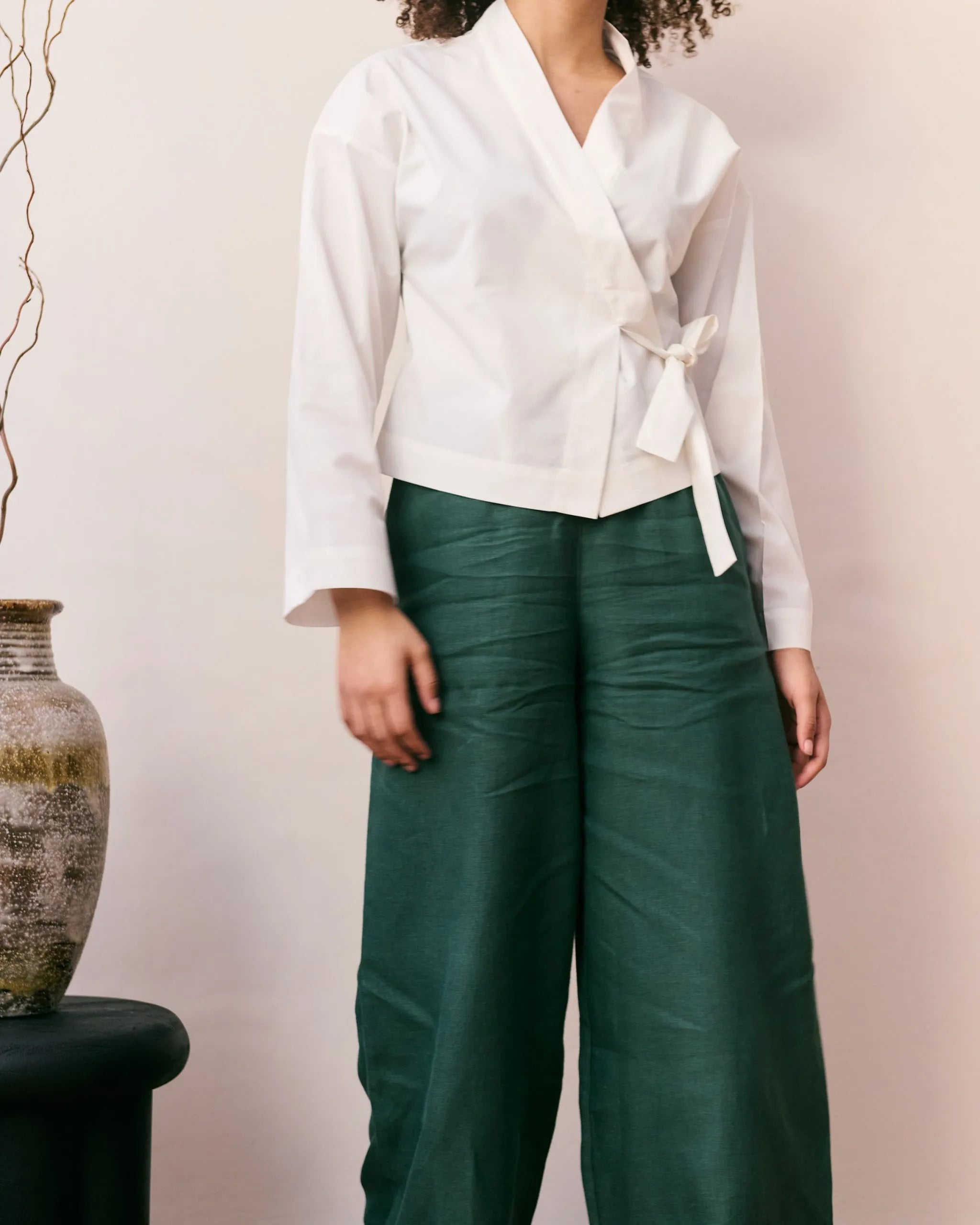 Off-white wrap blouse in 100% organic cotton and a green linen pants.
