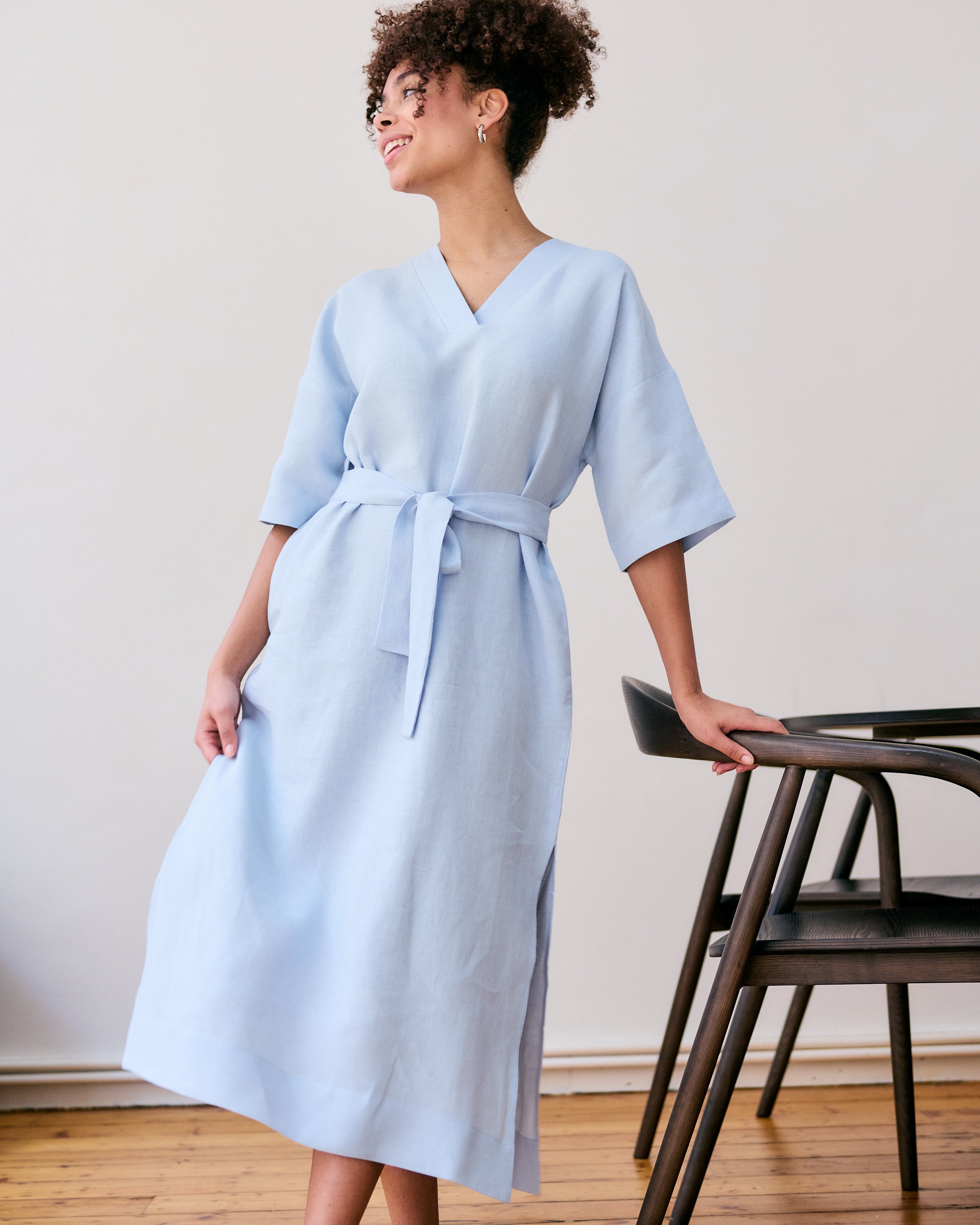 Comfortable, straight, light blue linen dress with belt.