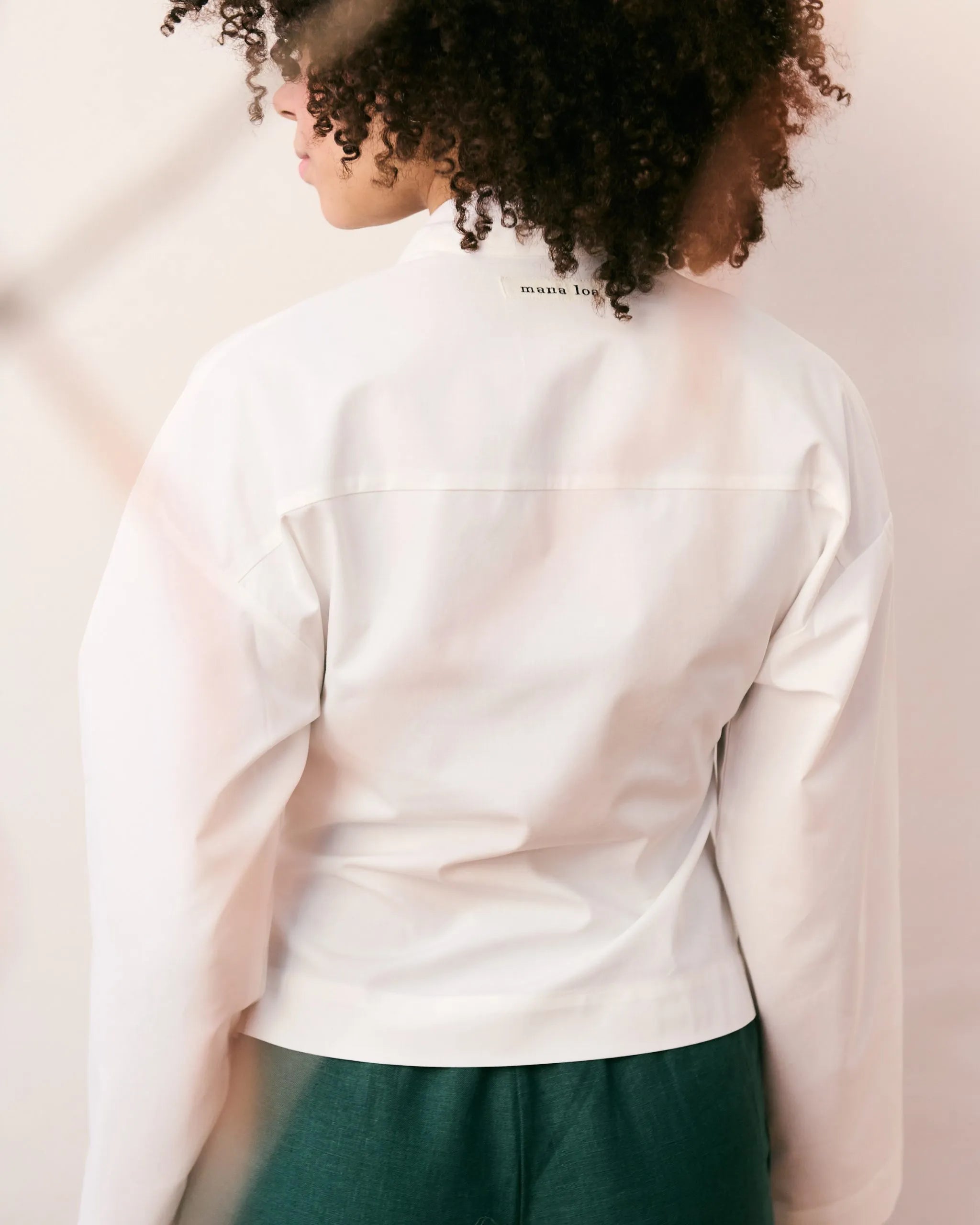 Back of an Offwhite wrap blouse in 100% organic cotton.